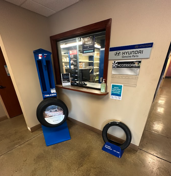 Hyundai parts and accessories counter at Crain Hyundai of Bentonville, featuring tires and signage